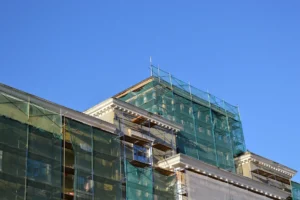 Netted facade scaffolding system by San Fernando Valley Scaffolding for debris control and worker safety